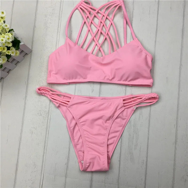 Women's pink cut out halter bikini swimsuit with bandage design and cross front details