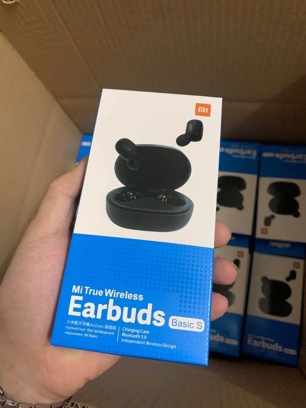 Black Redmi AirDots 2 true wireless earbuds and charging case on a white background