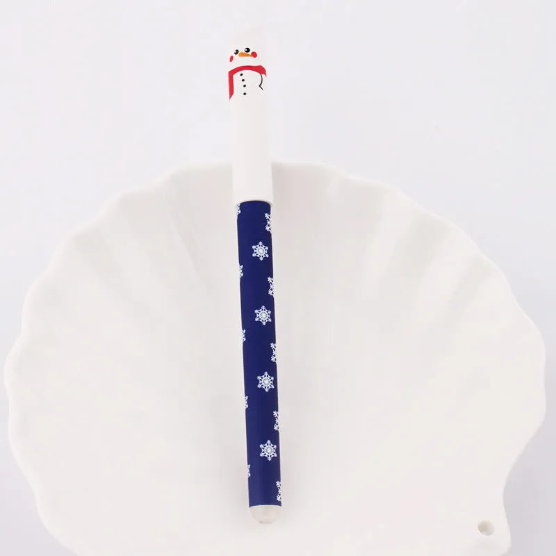 Four Christmas-themed erasable gel pens with Santa, gingerbread man, elk, and snowman designs on a white background