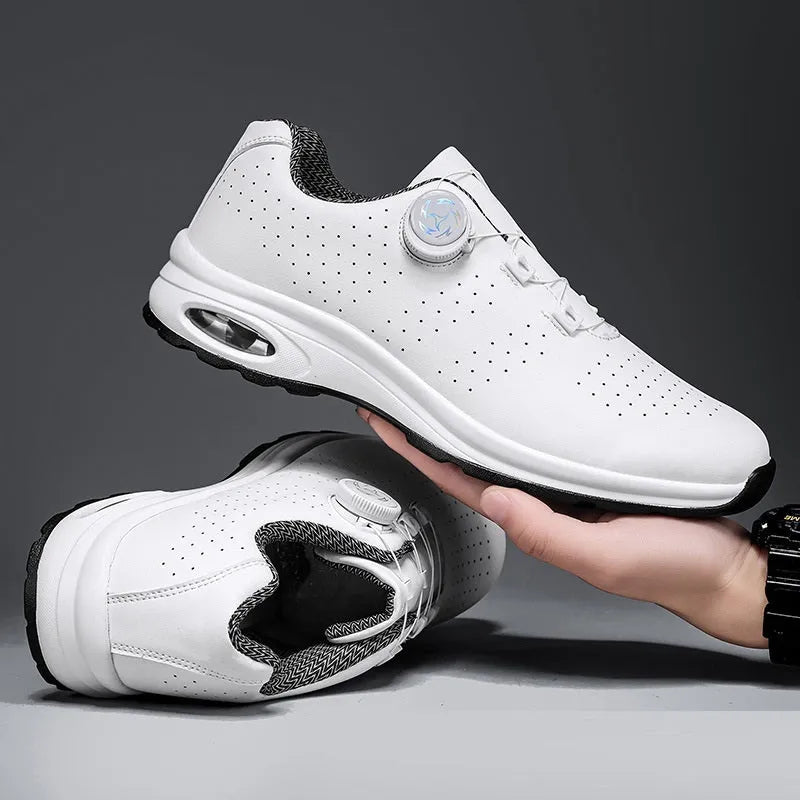 Black and white low top casual tennis shoes with mesh upper, cross shoulder straps, and composite sole.