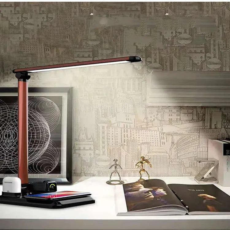 Black and white 4-in-1 LED desk lamp with wireless charging pad and adjustable lighting arm