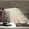 Black and white 4-in-1 LED desk lamp with wireless charging pad and adjustable lighting arm