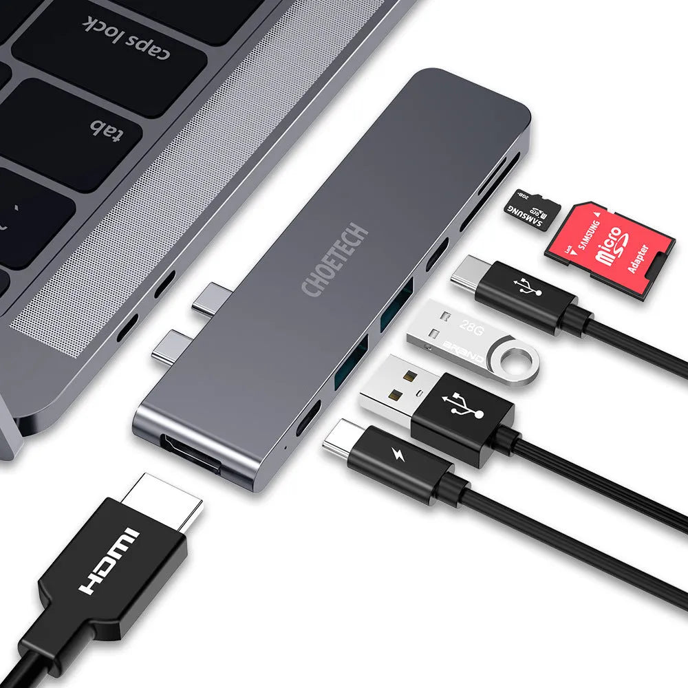 Compact aluminium USB-C hub showing ports: Thunderbolt 3, USB-C PD, HDMI, SD card slot, and two USB 3.0