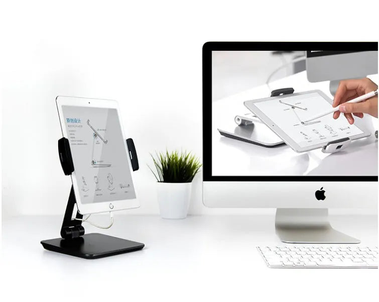 Silver aluminium folding phone and tablet stand on a desk, holding a tablet