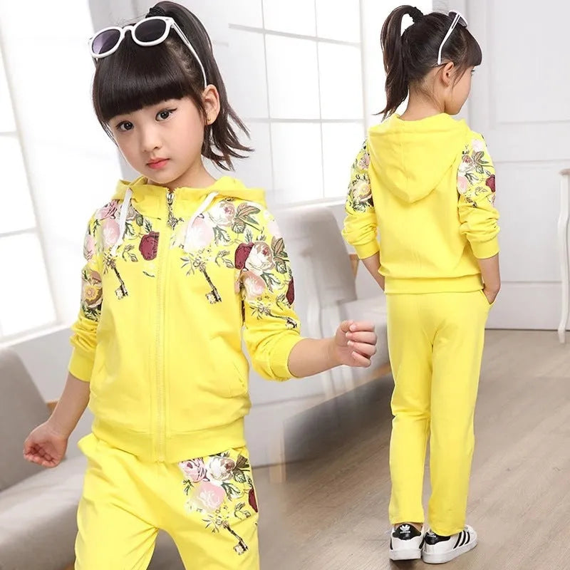 Children's pink hooded tracksuit set with long sleeves and matching trousers.