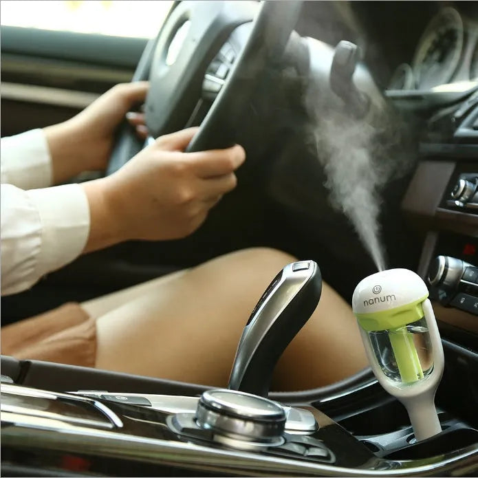 Blue portable car humidifier with essential oil diffuser function on car dashboard