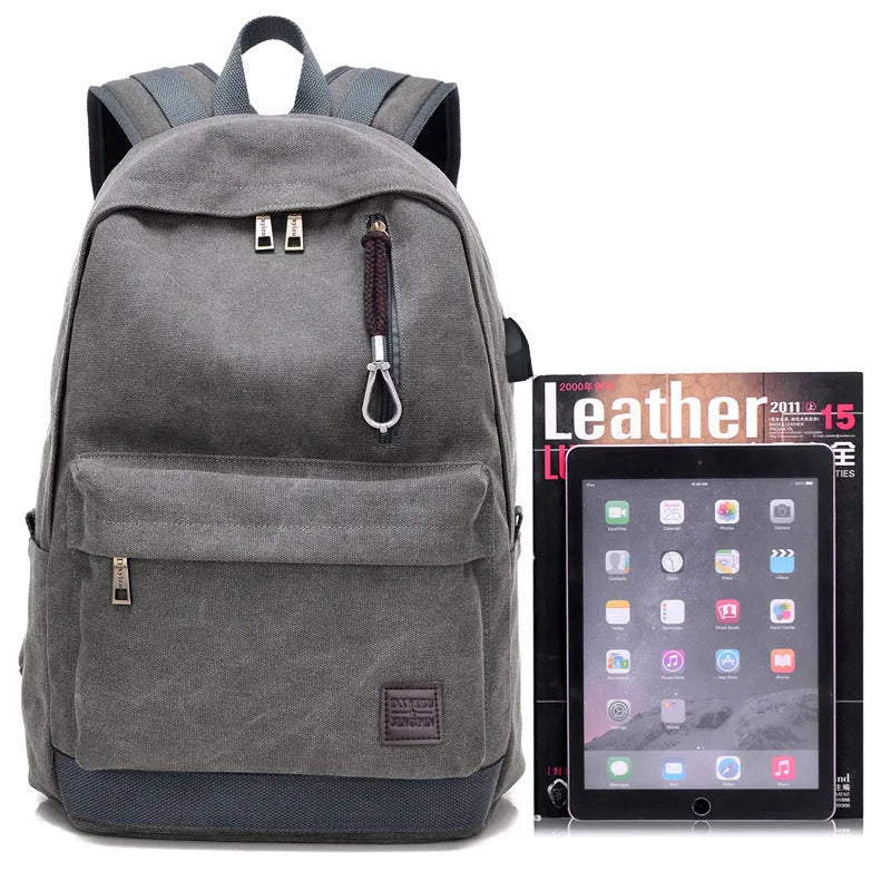 Canvas backpack with USB charging port showing computer compartment and multiple pockets