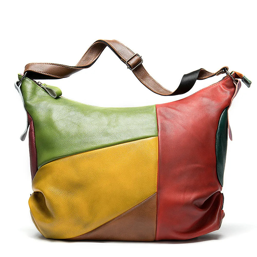 Brown cowhide leather travel crossbody shoulder bag with stitching detail, shown with a laptop and A4 magazine.