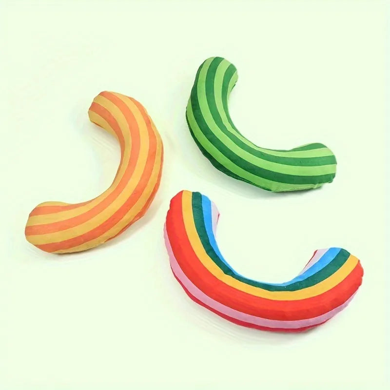 Set of cat toys including a noise maker with catnip and a green, rainbow, or yellow striped pillow.