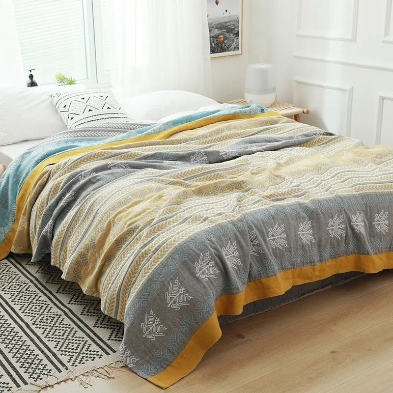 Pure cotton five-layer gauze towel blanket in Roulette Wheel Blue, shown on a bed.