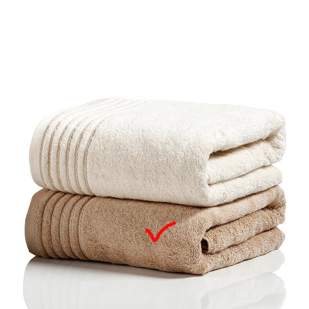 Beige and brown cotton towel set showing three sizes: square face cloth, hand towel, and bath towel.