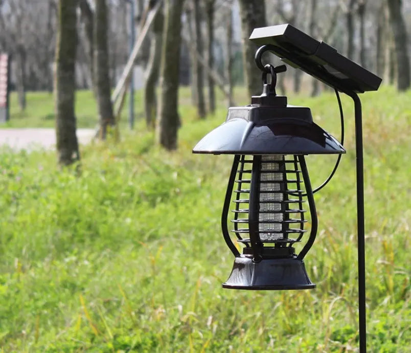 White and black solar-powered mosquito lamp with solar panel on top for outdoor garden use.