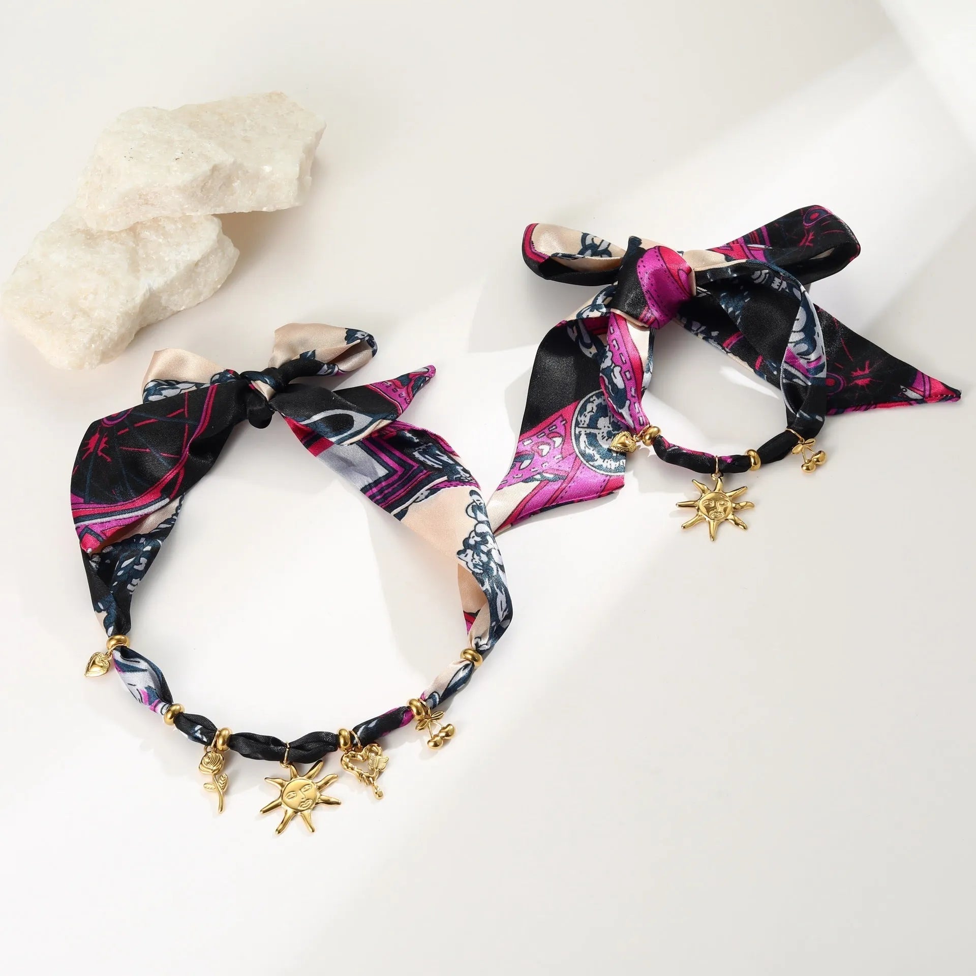 Geometric pendant on a gold chain, shown as a women's necklace or bracelet against an autumn backdrop.