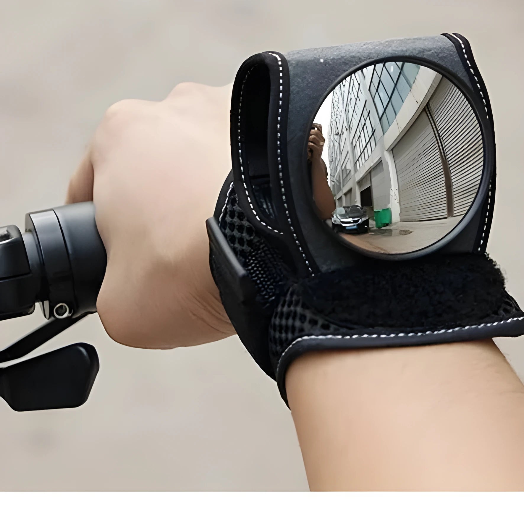 Bicycle wrist safety mirror with adjustable strap and anti-slip pad on a cyclist's wrist
