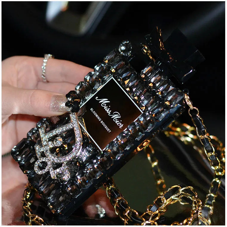 Perfume bottle bow design iPhone case with textured silicone and a metal chain strap.