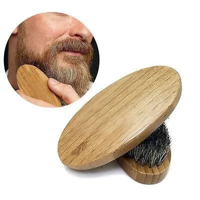 Natural boar beard brush for men in black finish with dense bristles on a table
