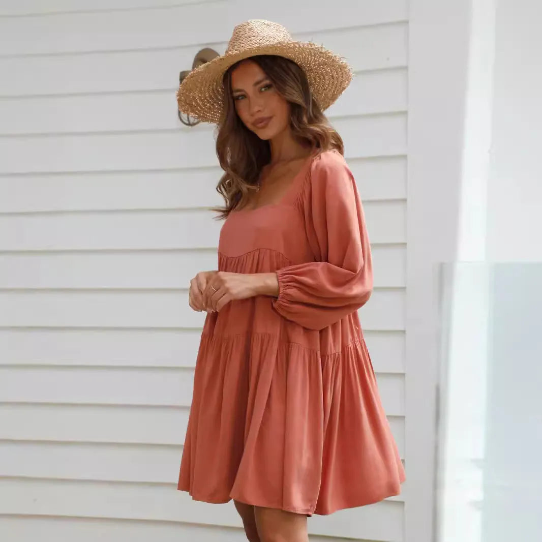 Orange backless children's dress with a square collar and puff sleeves in an A-line silhouette.