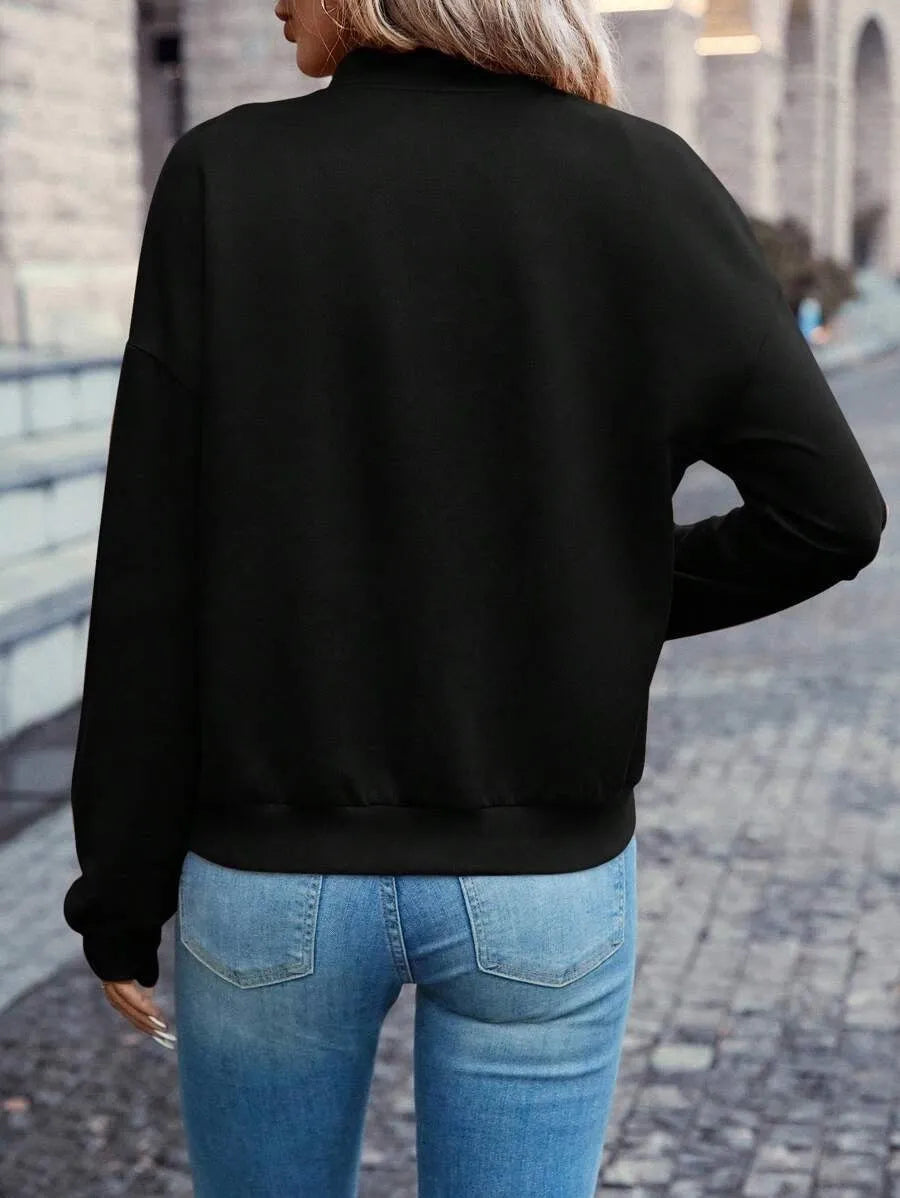 Black women's casual zip jacket with long sleeves on a hanger.