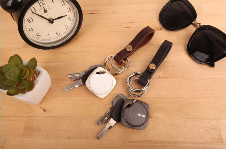 Compact Bluetooth tracker key finder with aluminium alloy shell and button, shown in black