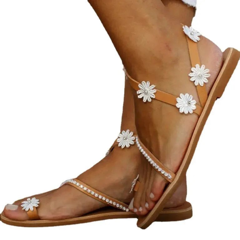 Brown Roman sandals with floral pattern, herringbone toe, and flat rubber sole