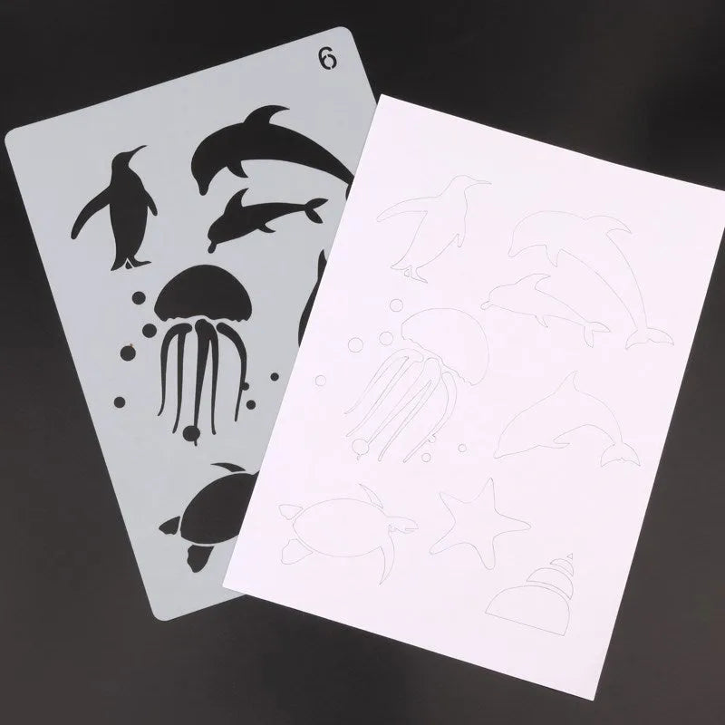 Set of white plastic drawing stencils with various cut-out design patterns