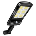 Black outdoor solar motion sensor wall light mounted on fence with LED illumination