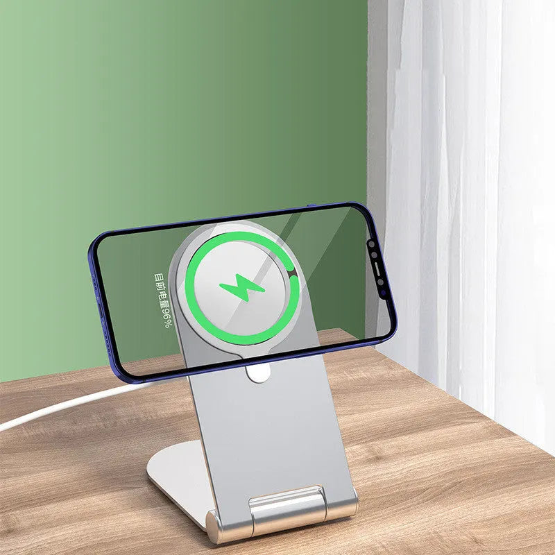 Silver vertical adjustable magnetic phone bracket for iPhone 12 series on a flat surface.