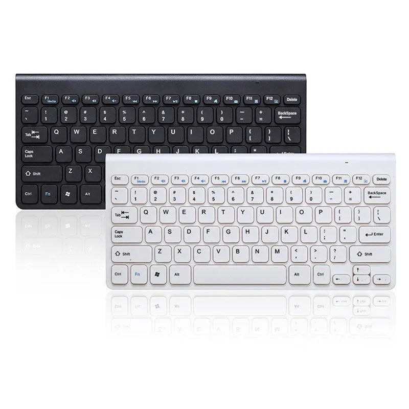 Black and white wireless keyboard and mouse set on a wooden desk.