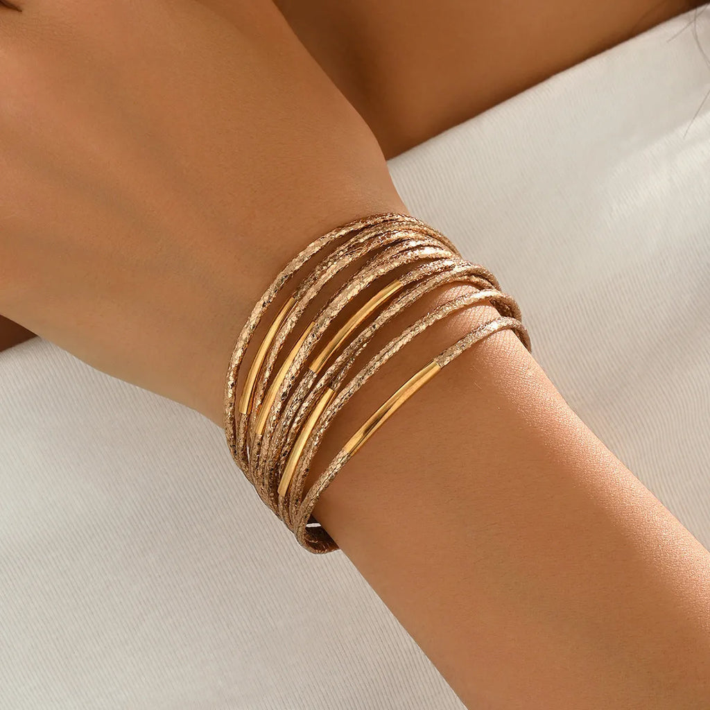 Multi-layer magnetic leather bracelet for women with round alloy element in gold, black, and coffee colours