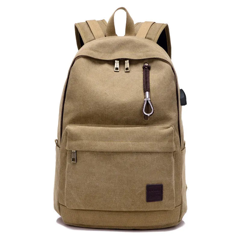 Canvas backpack with USB charging port showing computer compartment and multiple pockets