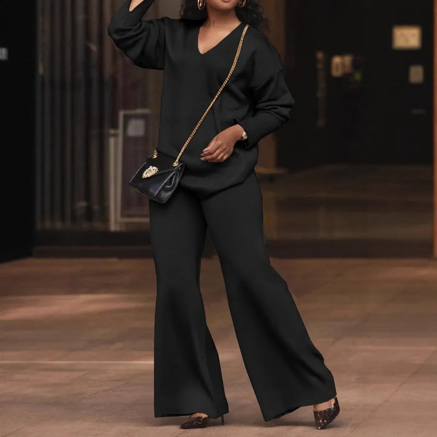 Women's brown thickened suede two-piece suit with split sleeve top and trousers on a hanger.