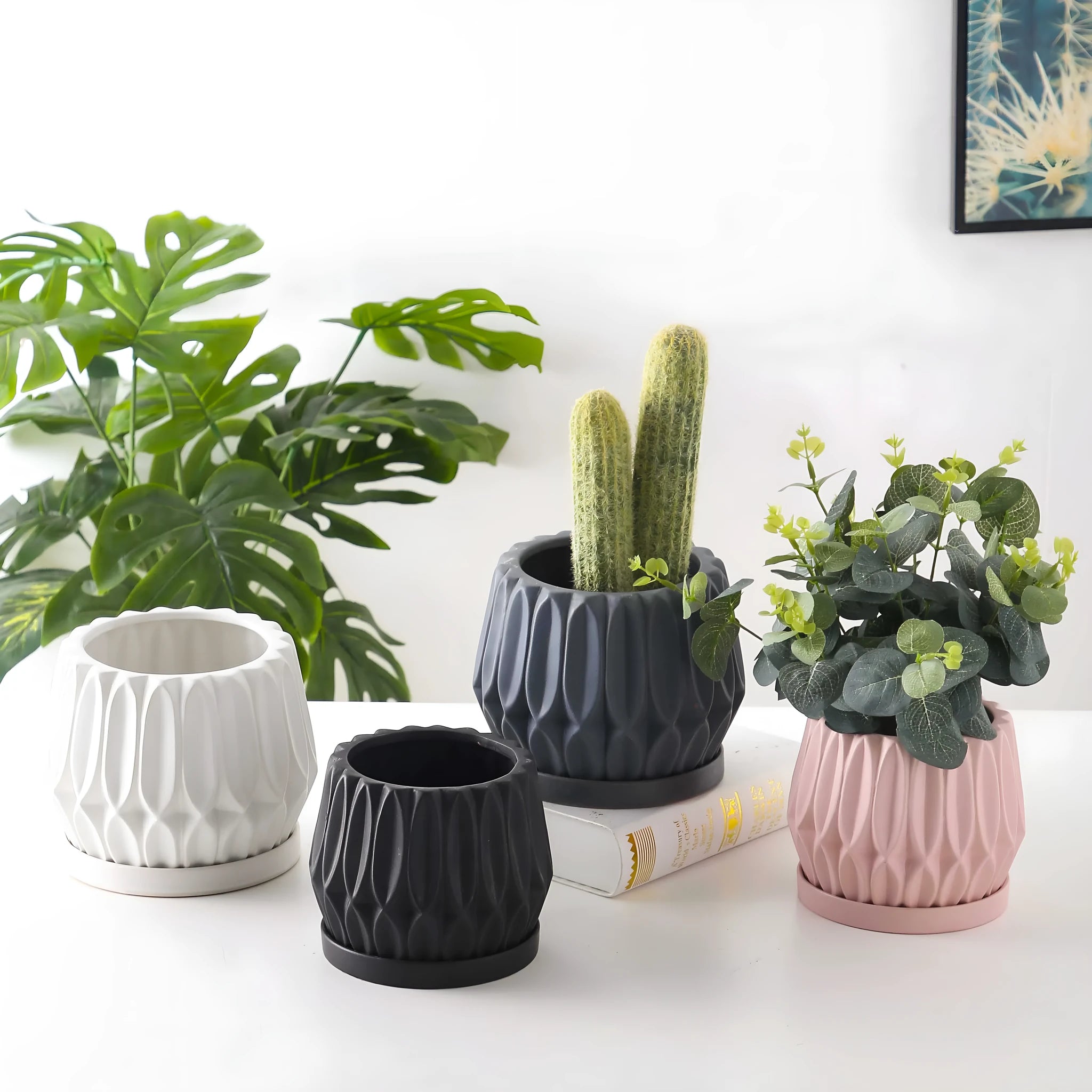 A simple grey ceramic flowerpot, medium-sized, for tabletop or floor plants.