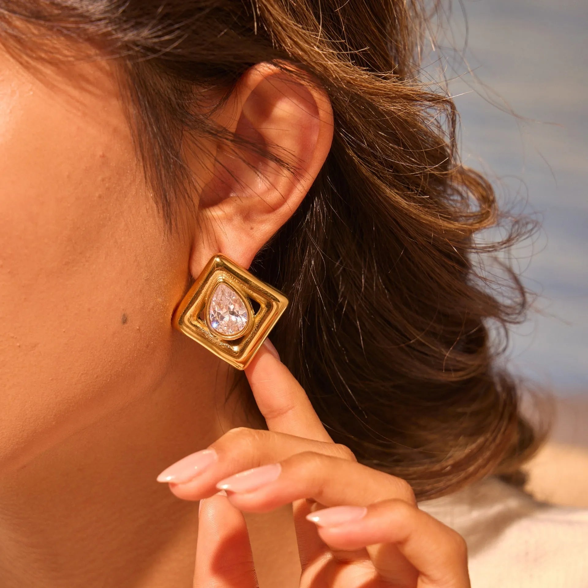 Gold geometric stud earrings with water drop zircon detail on stainless steel