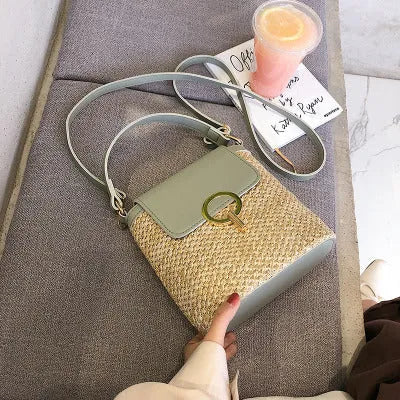 Women's straw woven bucket shoulder bag in black with cover flap, small size, polyester lining