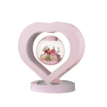 Pink preserved real rose ornament with optional base and Bluetooth audio speaker.