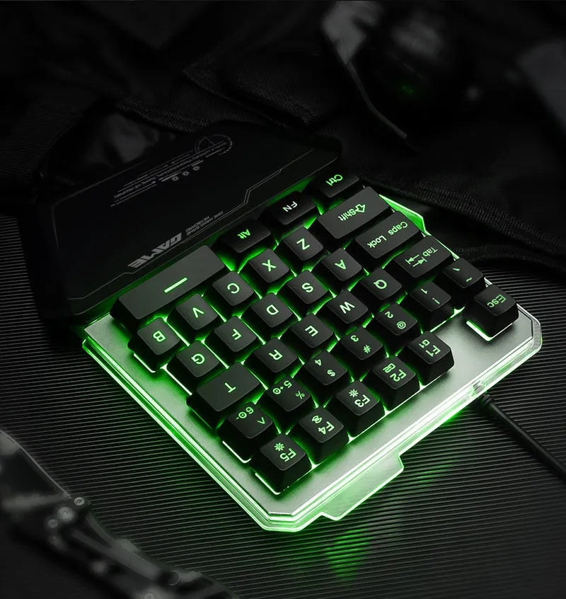 Black one-handed mechanical gaming keyboard with RGB backlit keys on a desk.