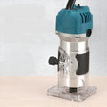 800W electric wood polishing trimmer with aluminium body on a workshop bench.