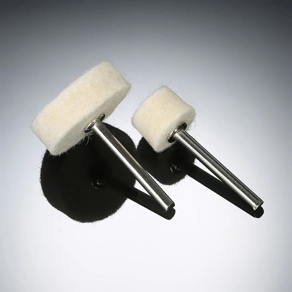 129 piece polishing wheel kit with white wool brushes and metal handles on a table