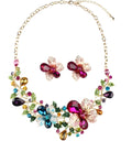 Crystal exaggeration chain necklace with gold-tone finish and faceted crystal links on a white background