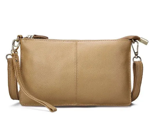 Lady cowhide slant bag showing hand strap and shoulder strap options with organised internal compartments