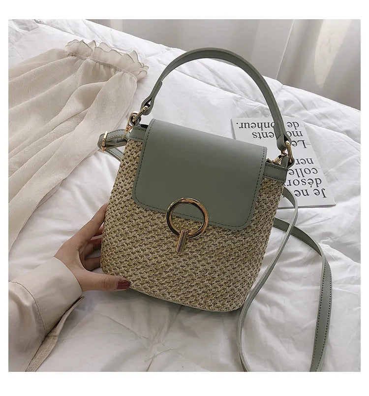Women's straw woven bucket shoulder bag in black with cover flap, small size, polyester lining