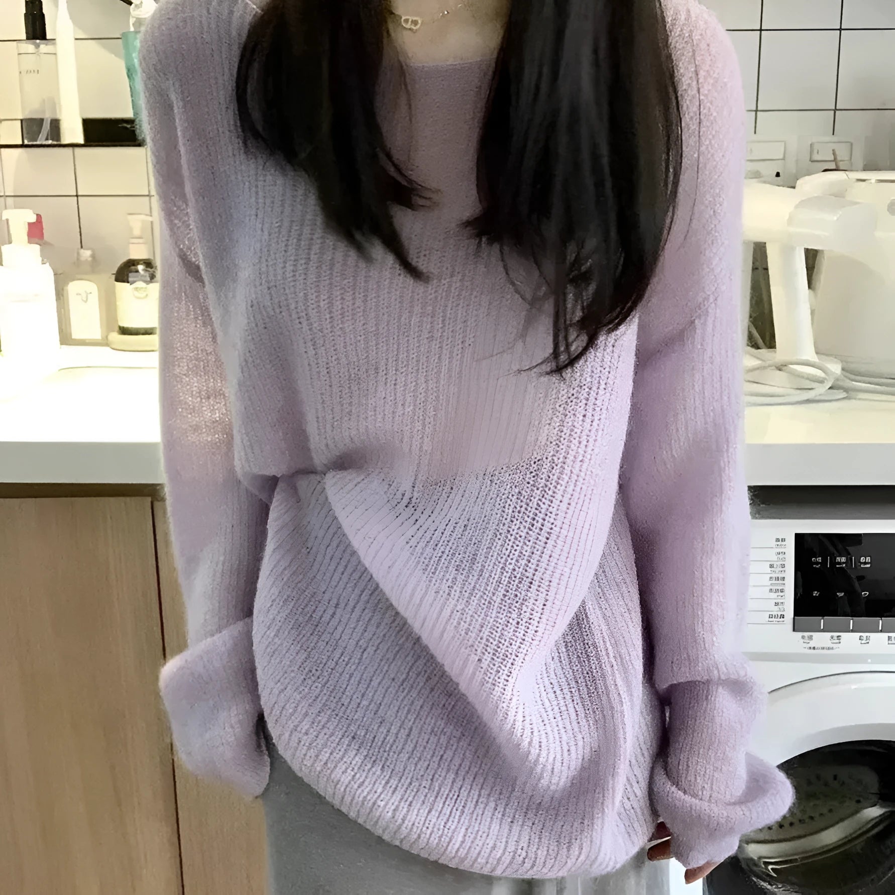 Purple women's round neck blouse with hollow-out detail and princess sleeves on a hanger.