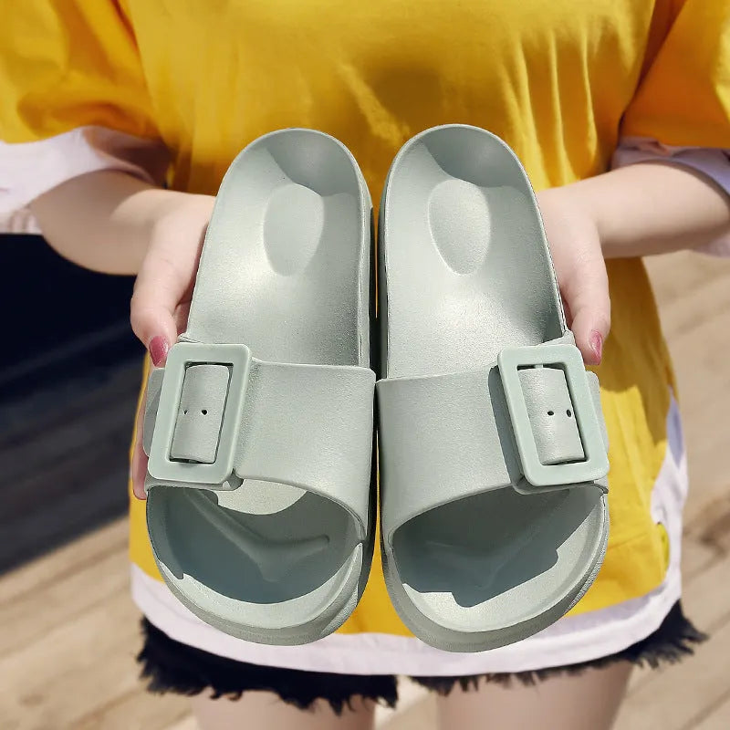 Women's grey blue buckle flip-flop sandals with a soft EVA sole on a plain background