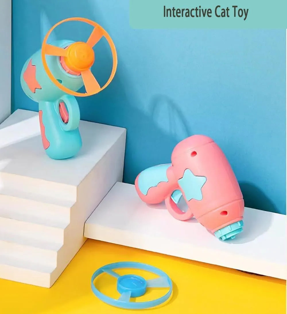 Blue plastic cat toy gun with spinning Frisbee disc for indoor cat play