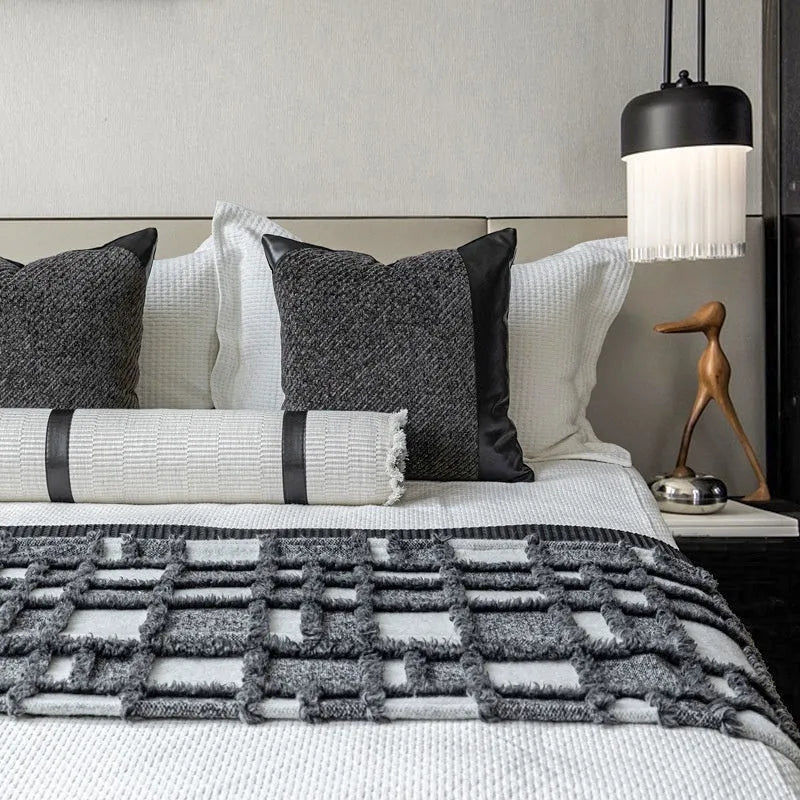 Modern minimalist grey and white plaid polyester bed runner set with pillowcase and round pillow on a bed.