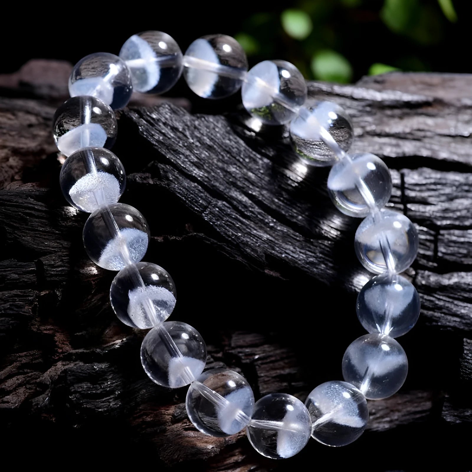 Women's white crystal pyramid bracelet with Ruyi symbols on wrist, showing ground bead texture.