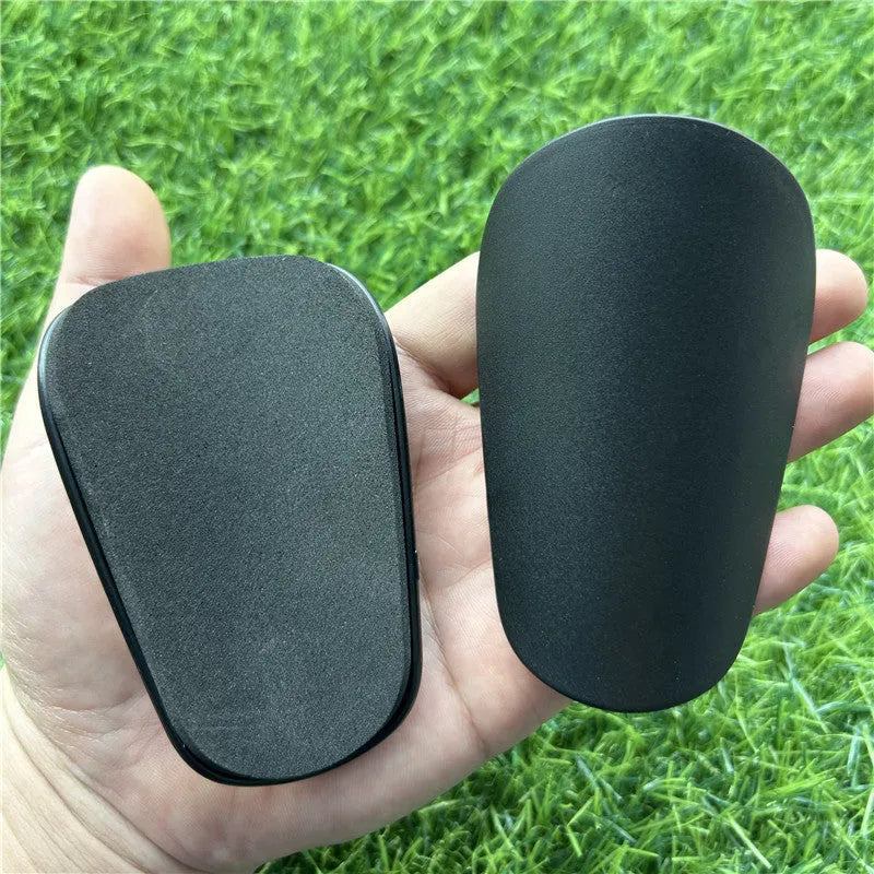 Black and white extra small plastic football shin guards for junior players