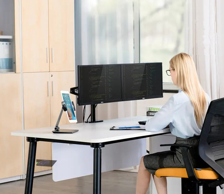 Silver aluminium folding phone and tablet stand on a desk, holding a tablet