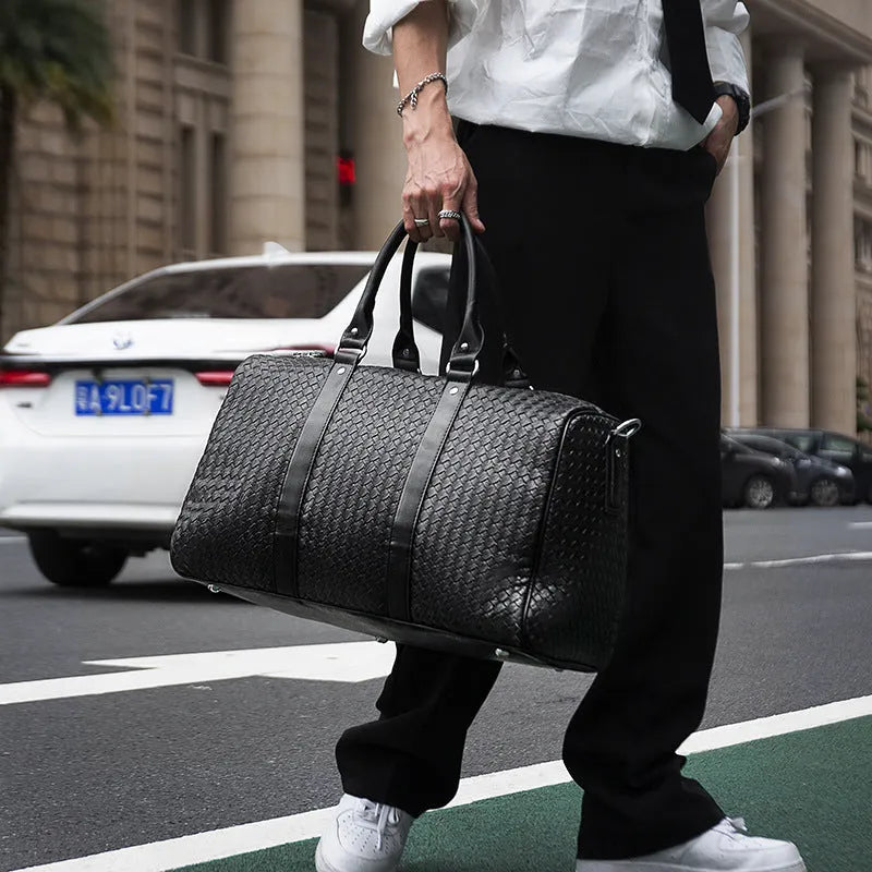 Black medium PU leather shoulder bag with woven texture and zipper closure for travel and business use