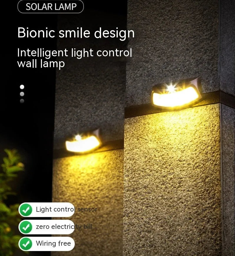 Solar-powered outdoor wall lamp with smiling face design for garden lighting